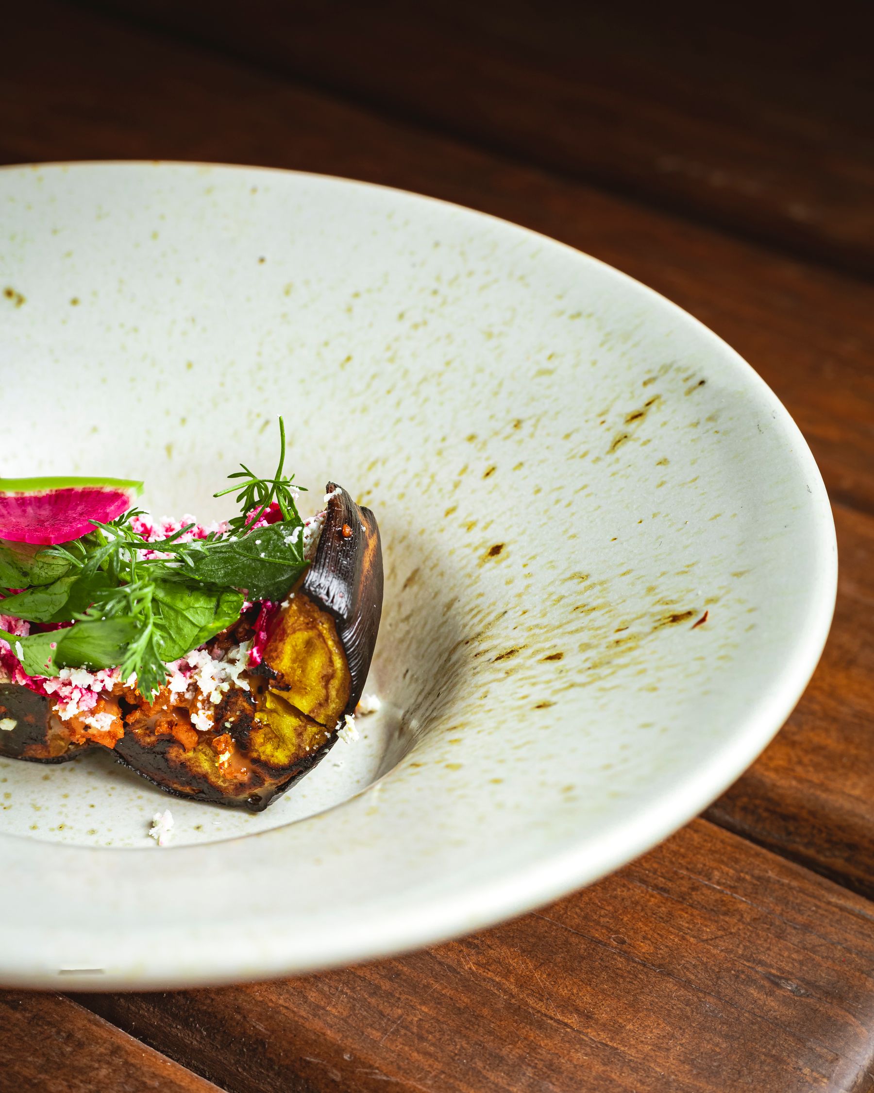 A plated dish with fresh herbs on a white plate