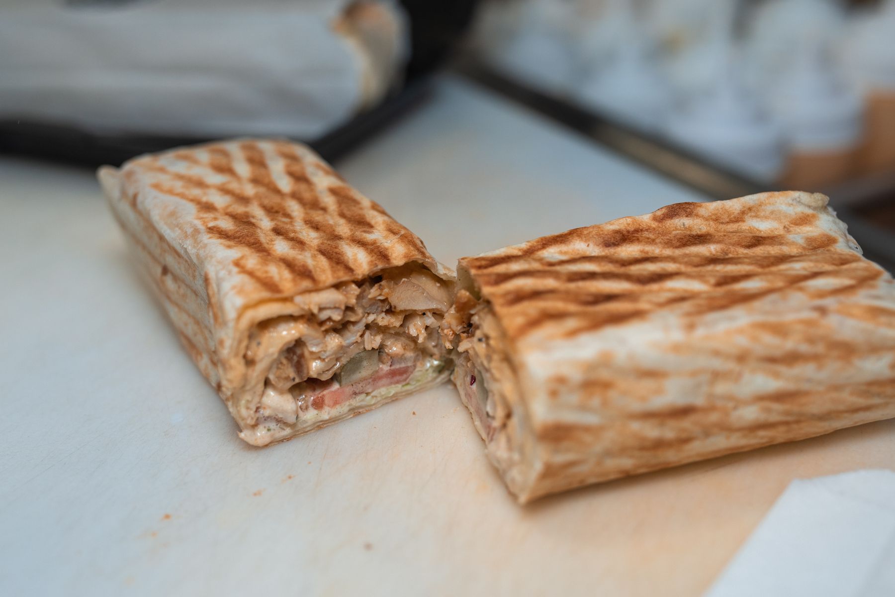 A grilled shawarma wrap sliced in half