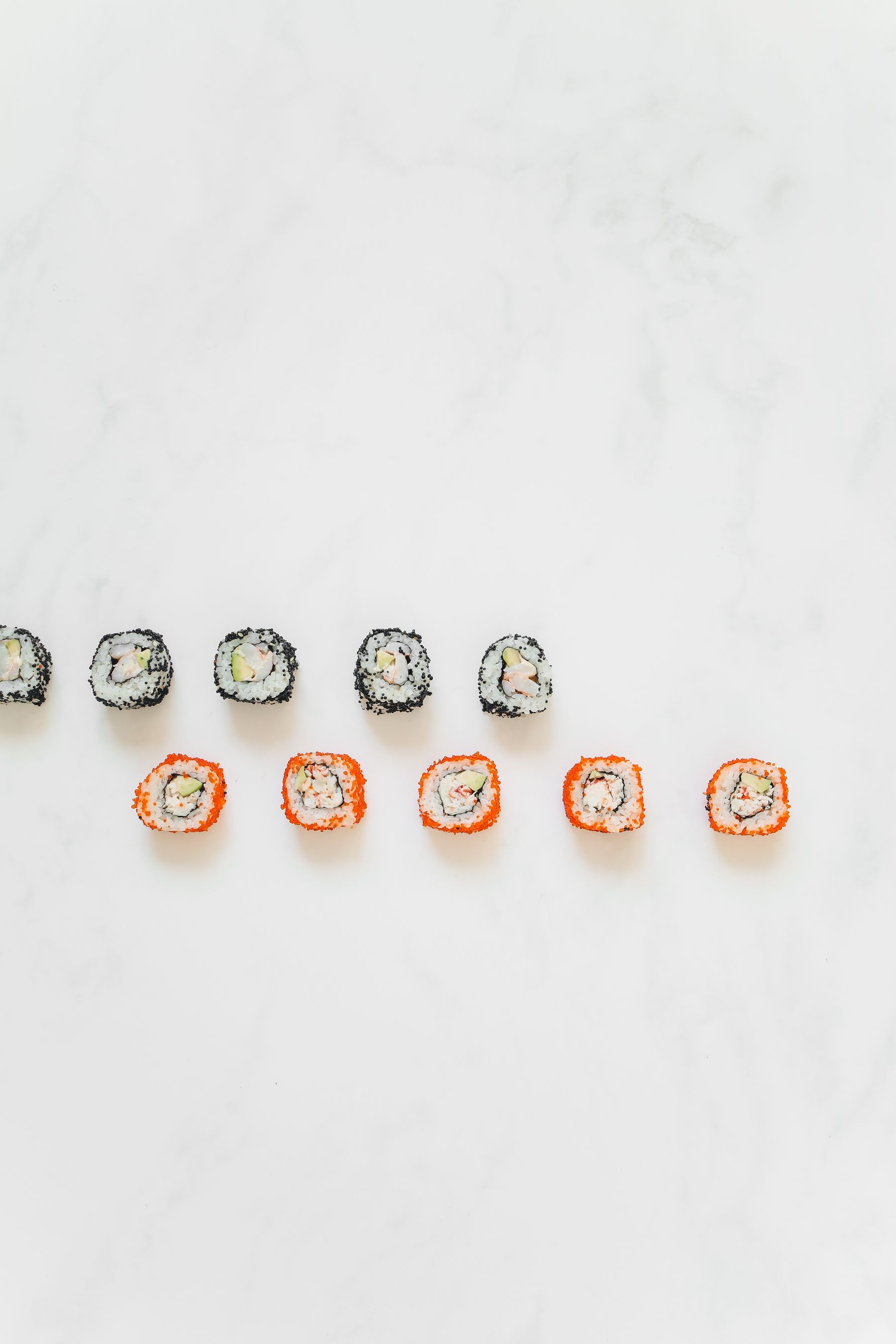 Sushi rolls arranged on a marble table